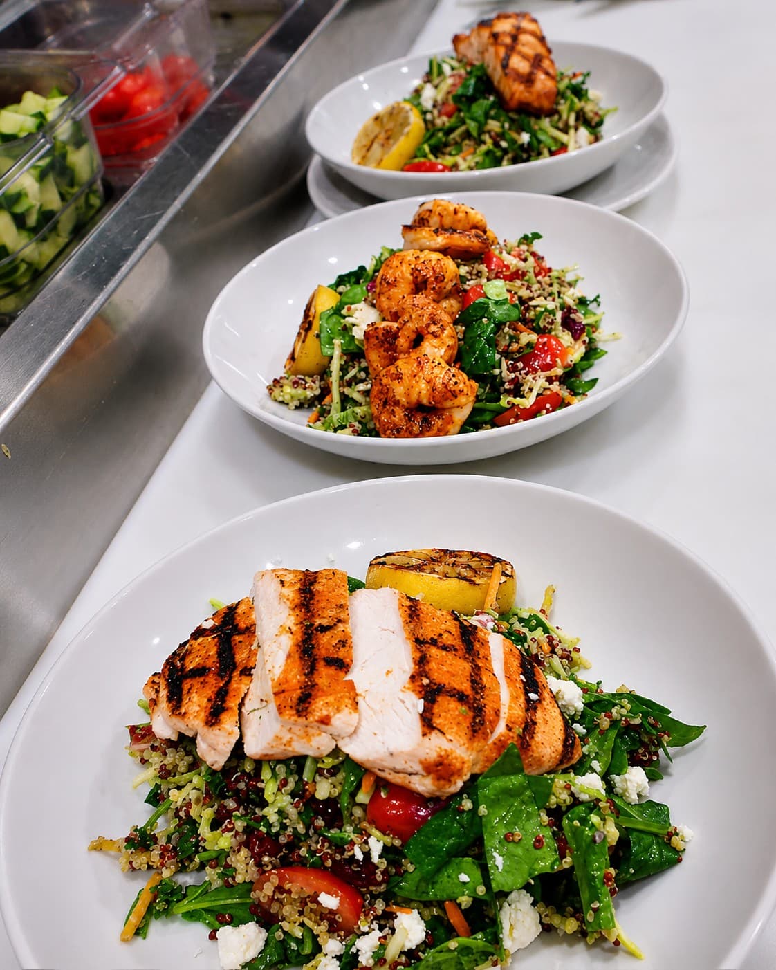 Grilled chicken and shrimp quinoa salads prepared by Maria Mosquera.
